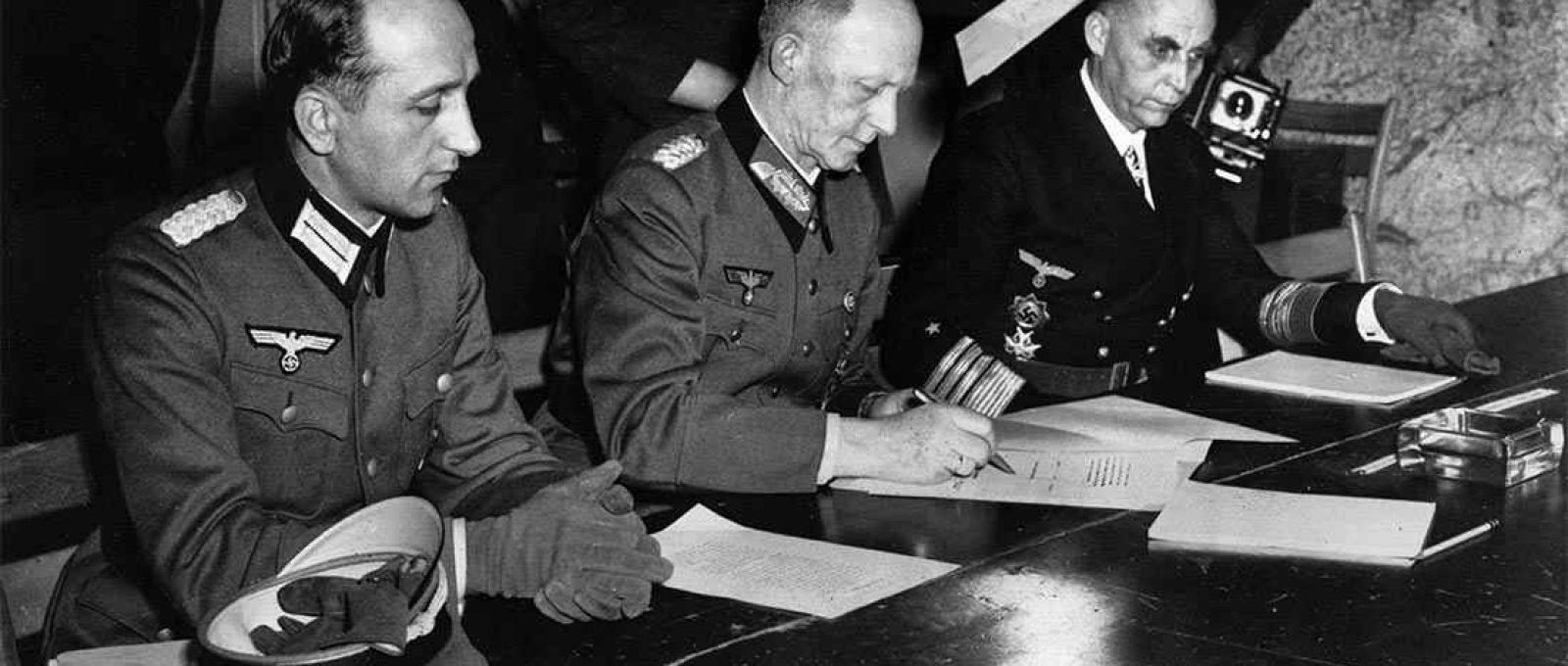 O general Alfred Jodl, ao centro, assina a rendição incondicional de todas as forças armadas alemãs em 7 de maio de 1945 (Foto: AP).