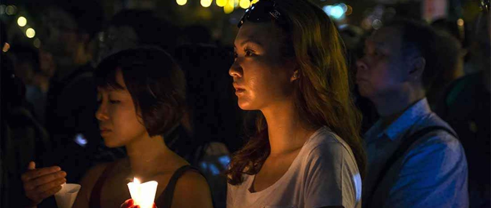 Mulher segura uma vela durante a cerimônia pelas vítimas da Praça da Paz Celestial durante uma vigília em Hong Kong em 4 de junho de 2016 (Foto: Albert Bonsfills/Anadolu).