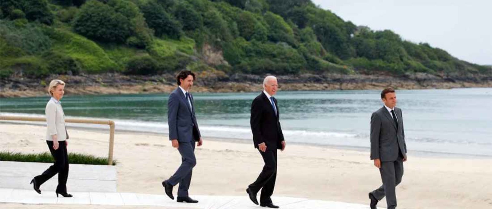 A presidente da Comissão Europeia, Ursula von der Leyen, o primeiro-ministro do Canadá, Justin Trudeau, o presidente dos Estados Unidos, Joe Biden, e o presidente da França, Emmanuel Macron, caminham ao longo do calçadão durante a cúpula do G7 em Carbis Bay, na Cornualha, sudoeste da Inglaterra, em 11 de junho de 2021 (Phil Noble/AFP via Getty Images).